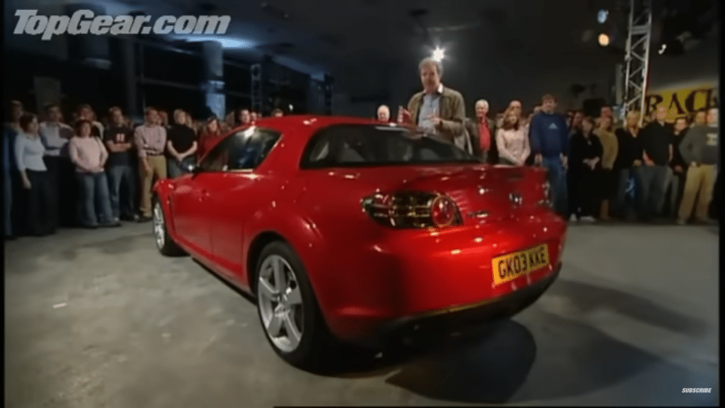 Jeremy Clarkson stoji pored crvene Mazde